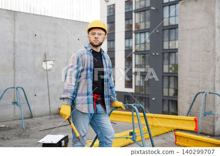 Worker wearing hard hat and safety glasses on building site Worker wearing hard hat and safety glasses on building site 140299707
