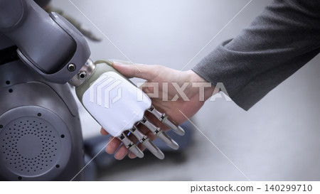 AI Robot shaking hands with man. Close up of human shaking hand with robotic arm. Symbolizing collaborate between people and artificial intelligence or AI. Automation robot innovate future technology AI Robot shaking hands with man. Close up of human shaking hand with robotic arm. Symbolizing collaborate between people and artificial intelligence or AI. Automation robot innovate future technology 140299710