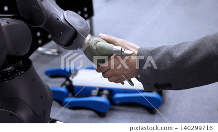 AI Robot shaking hands with man. Close up of human shaking hand with robotic arm. Symbolizing collaborate between people and artificial intelligence or AI. Automation robot innovate future technology AI Robot shaking hands with man. Close up of human shaking hand with robotic arm. Symbolizing collaborate between people and artificial intelligence or AI. Automation robot innovate future technology 140299716