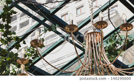 Chandelier hanging in Moscow greenhouse with glass roof Chandelier hanging in Moscow greenhouse with glass roof 140299800