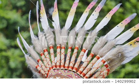 Indian headdress crafted with feathers and fur, symbolizing traditional tribal heritage Indian headdress crafted with feathers and fur, symbolizing traditional tribal heritage 140299902