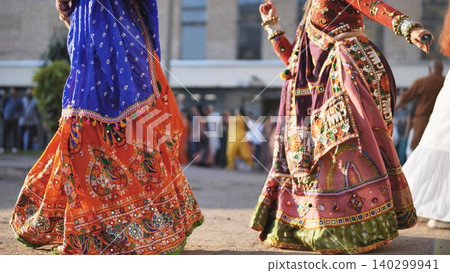 Celebrating Ganesh Chaturthi festival with people dancing Garba in vibrant Indian clothes Celebrating Ganesh Chaturthi festival with people dancing Garba in vibrant Indian clothes 140299941