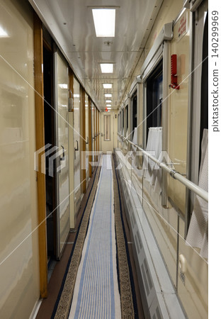 Train interior corridor with windows and compartments, showcasing railway travel Train interior corridor with windows and compartments, showcasing railway travel 140299969