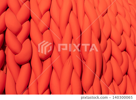 Abstract orange braided fabric creating a vibrant pattern and soft textile background Abstract orange braided fabric creating a vibrant pattern and soft textile background 140300065