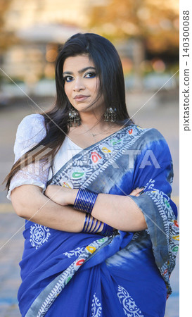 Bangladeshi woman wearing traditional blue saree with jewelry in Moscow city Bangladeshi woman wearing traditional blue saree with jewelry in Moscow city 140300088