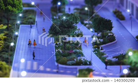 Modern city planning model showing urban area at night with streets and people Modern city planning model showing urban area at night with streets and people 140300209