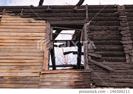 Burnt house structure showing extensive fire damage and destructive aftermath Burnt house structure showing extensive fire damage and destructive aftermath 140300211