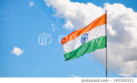 India national flag flying against blue sky, symbolizing patriotism and independence India national flag flying against blue sky, symbolizing patriotism and independence 140300323