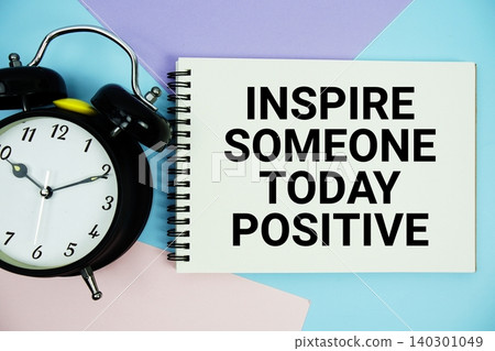 Inspire Someone Today Positive text written on notepad with alarm clock flat lay on multicolor pastel background Inspire Someone Today Positive text written on notepad with alarm clock flat lay on multicolor pastel background 140301049