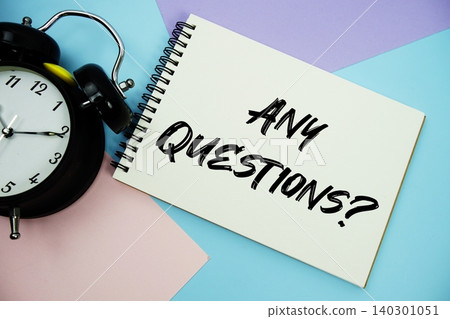 Any Questions text written on notepad with alarm clock flat lay on multicolor pastel background Any Questions text written on notepad with alarm clock flat lay on multicolor pastel background 140301051