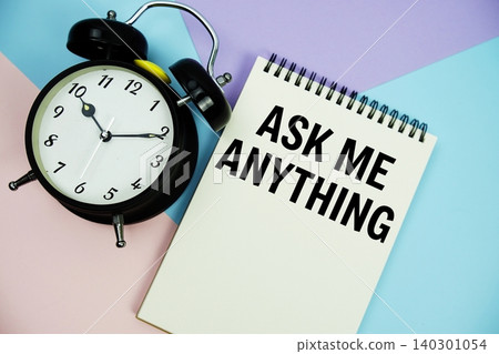 Ask Me Anything text written on notepad with alarm clock flat lay on multicolor pastel background Ask Me Anything text written on notepad with alarm clock flat lay on multicolor pastel background 140301054