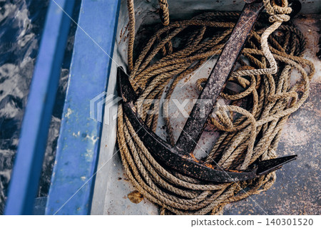 Metal anchor lying on board boat sailing on lake, sea vacation on ship Metal anchor lying on board boat sailing on lake, sea vacation on ship 140301520