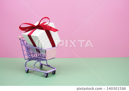 Shopping Cart and Gift Box on pink background with copy space Shopping Cart and Gift Box on pink background with copy space 140301586