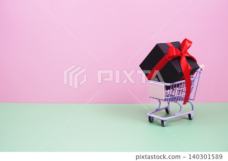 Shopping Cart and Gift Box on pink background with copy space Shopping Cart and Gift Box on pink background with copy space 140301589