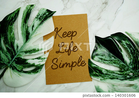Keep Life Simple text with monstera leave on marble background Keep Life Simple text with monstera leave on marble background 140301606