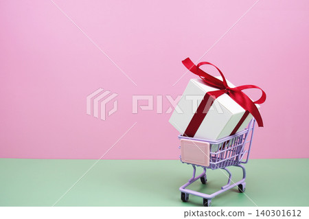 Shopping Cart and Gift Box on pink background with copy space Shopping Cart and Gift Box on pink background with copy space 140301612