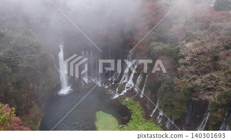 Shiraito Falls in autumn, shrouded in a mystical mist resembling a sea of clouds. Shiraito Falls in autumn, shrouded in a mystical mist resembling a sea of clouds. 140301693
