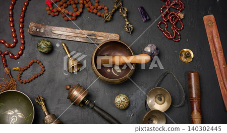 Tibetan singing bowl, wooden resonator, ritual vajras, bell, prayer wheel, rosary beads, and incense Tibetan singing bowl, wooden resonator, ritual vajras, bell, prayer wheel, rosary beads, and incense 140302445