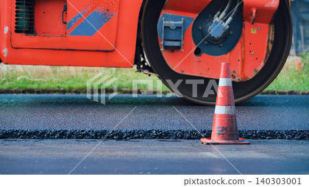 Road roller compacting fresh asphalt during highway construction and infrastructure work Road roller compacting fresh asphalt during highway construction and infrastructure work 140303001