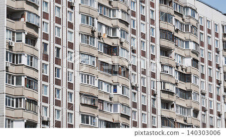 Facade of a residential building with many balconies and windows is showing urban density Facade of a residential building with many balconies and windows is showing urban density 140303006