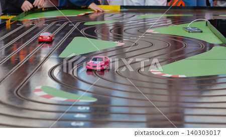 Children playing slot car racing game on Sports Day Children playing slot car racing game on Sports Day 140303017