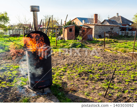 burning cut tree branches in barrel with chimney burning cut tree branches in barrel with chimney 140303092