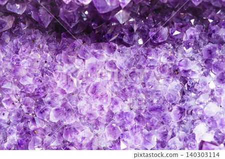 raw amethyst crystals in druse close-up 140303114