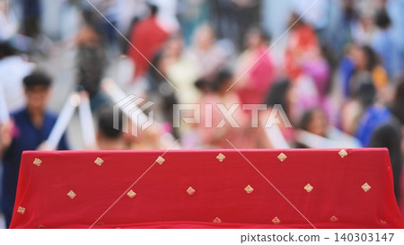 Ganesh Chaturthi festival celebrating crowded street scene with red embroidered fabric Ganesh Chaturthi festival celebrating crowded street scene with red embroidered fabric 140303147