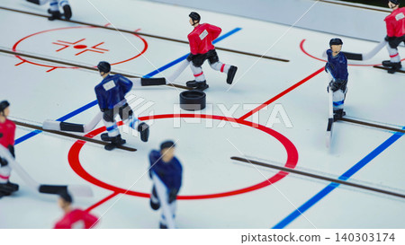 A dynamic close up of a classic table hockey board game with red and blue players A dynamic close up of a classic table hockey board game with red and blue players 140303174