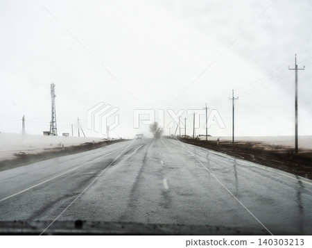 view through windshield while driving in rain view through windshield while driving in rain 140303213