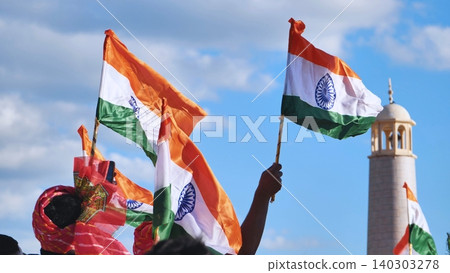 India Day celebration in Moscow, people waving Indian flags under blue sky India Day celebration in Moscow, people waving Indian flags under blue sky 140303278
