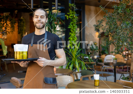 Friendly waiter holding tray with napkins Friendly waiter holding tray with napkins 140303351