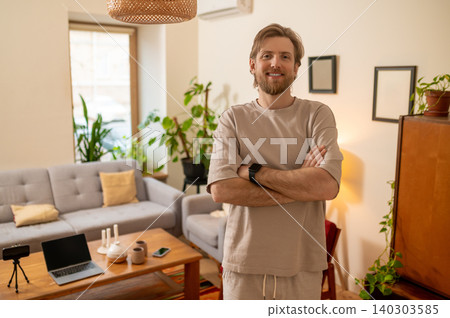 Fair-haired bearded man standing in the middle of the room and looking confident and resolute Fair-haired bearded man standing in the middle of the room and looking confident and resolute 140303585