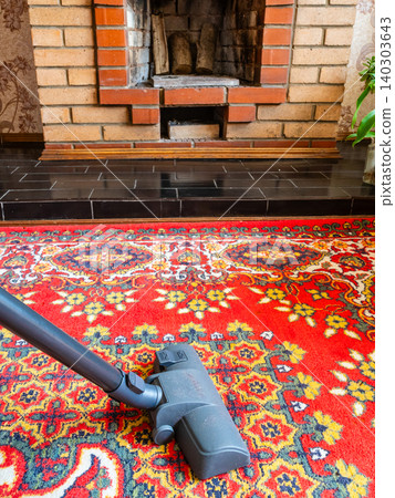vacuum cleaner cleans carpet near fireplace vacuum cleaner cleans carpet near fireplace 140303643