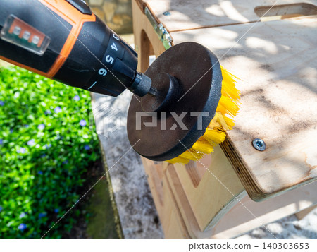 cleaning surface of bench from dust using brush cleaning surface of bench from dust using brush 140303653