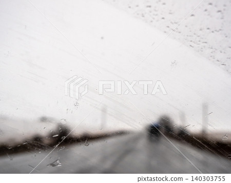 view of car's windshield being cleaned by wipers view of car's windshield being cleaned by wipers 140303755