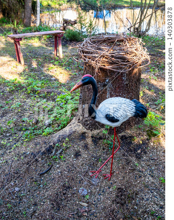 stork figurine and nest made on cut tree stump stork figurine and nest made on cut tree stump 140303878