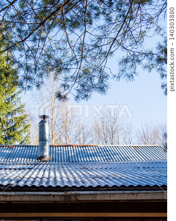 forest cabin roof surrounded by coniferous trees forest cabin roof surrounded by coniferous trees 140303880