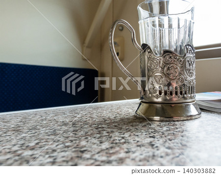 glass in cup holder close up on table in train glass in cup holder close up on table in train 140303882