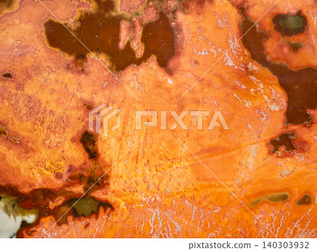 surface of polished orange jasper rock close-up 140303932