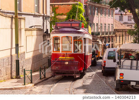 Historic Red Tram on Narrow Street in Lisbon Portugal Historic Red Tram on Narrow Street in Lisbon Portugal 140304213
