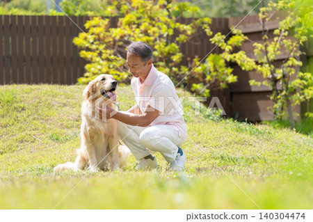 Senior man taking care of a large dog Senior man taking care of a large dog 140304474