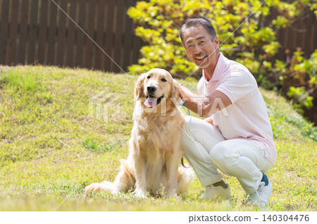 Senior man playing with a dog Senior man playing with a dog 140304476