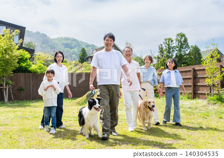 A three-generation family walking their dog A three-generation family walking their dog 140304535