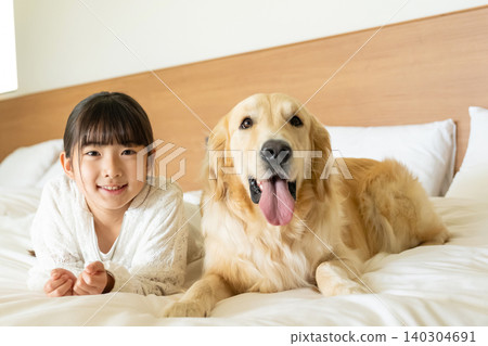 A girl playing with a dog A girl playing with a dog 140304691