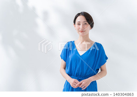 A smiling woman in summer clothes A smiling woman in summer clothes 140304863