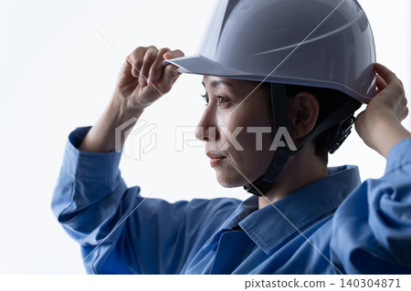 Female worker working at a construction site Female worker working at a construction site 140304871