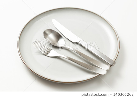 Plates and cutlery against a white background Plates and cutlery against a white background 140305262