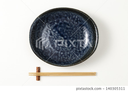 A Mino ware plate and chopsticks against a white background. A Mino ware plate and chopsticks against a white background. 140305311