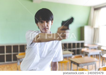 Boy pointing a gun Boy pointing a gun 140305479